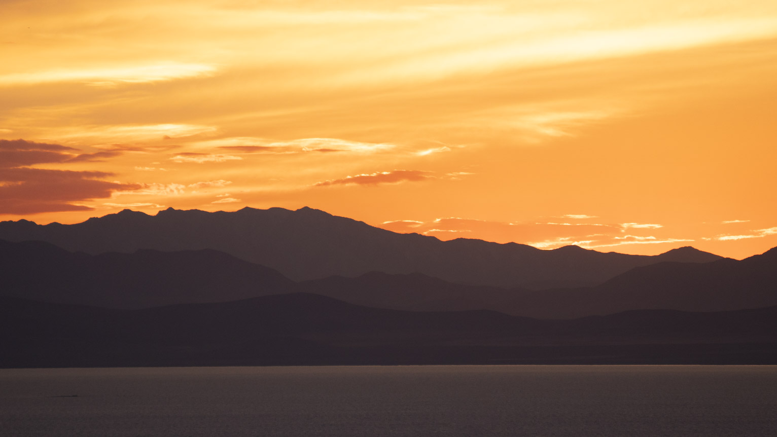 Layers of mountains in purplish light at sunset